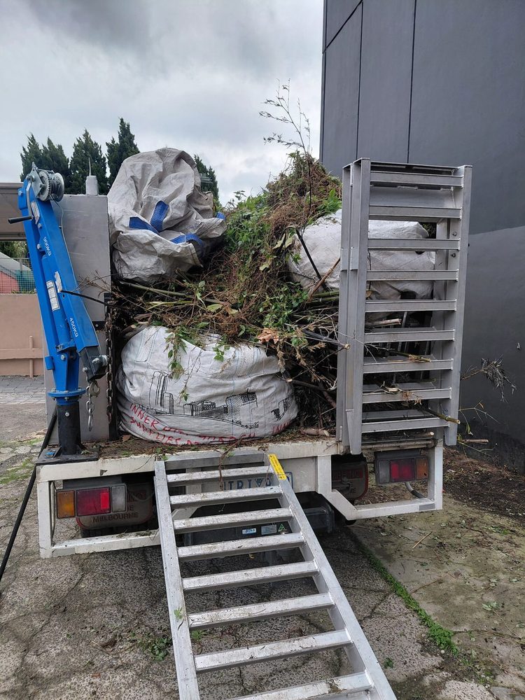 A truck loaded with bagged green waste ready for removal from a Melbourne property