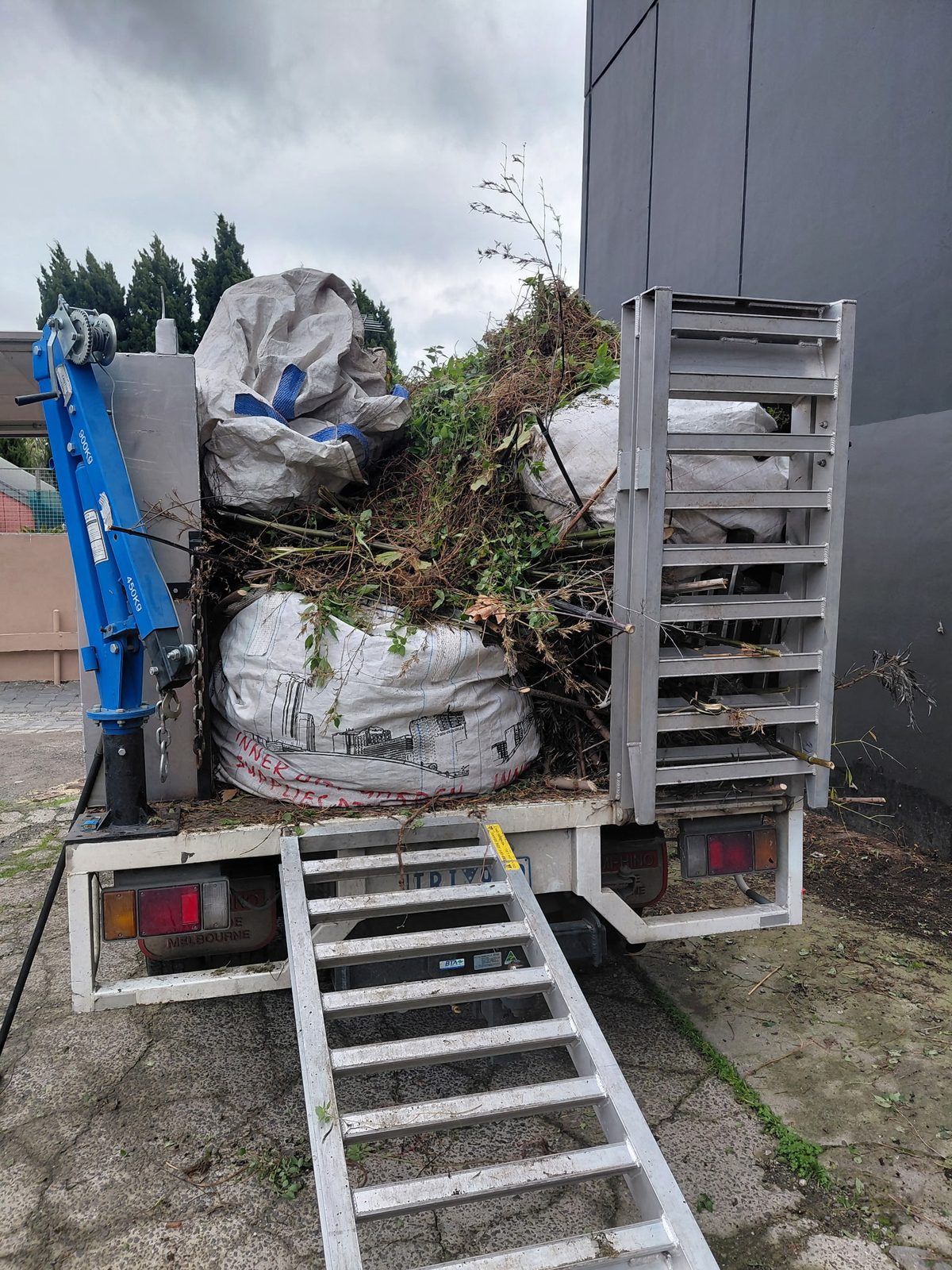 A truck loaded with bagged green waste ready for removal from a Melbourne property