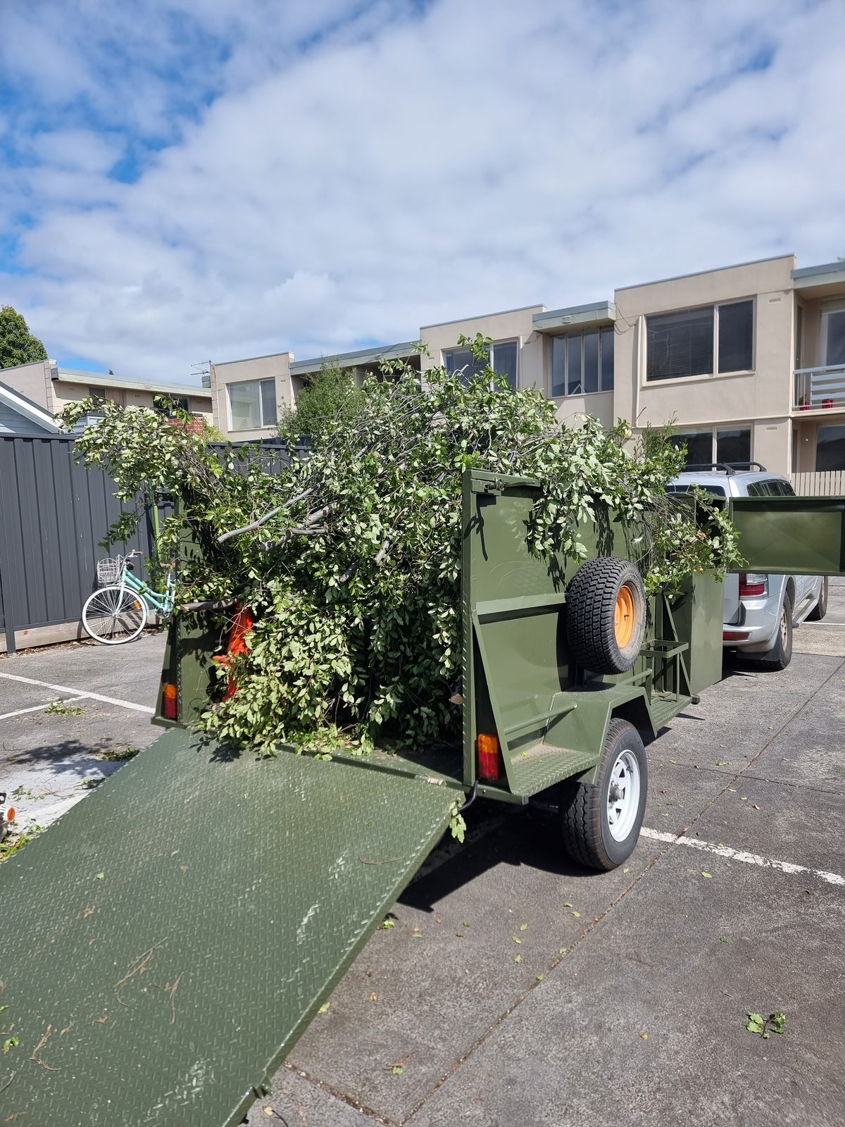 A trailer loaded with branches and garden clippings for green waste removal